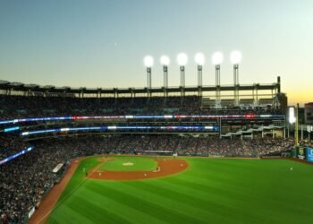 A vibrant twilight baseball game at Cleveland's Progressive Field, capturing the lively atmosphere.